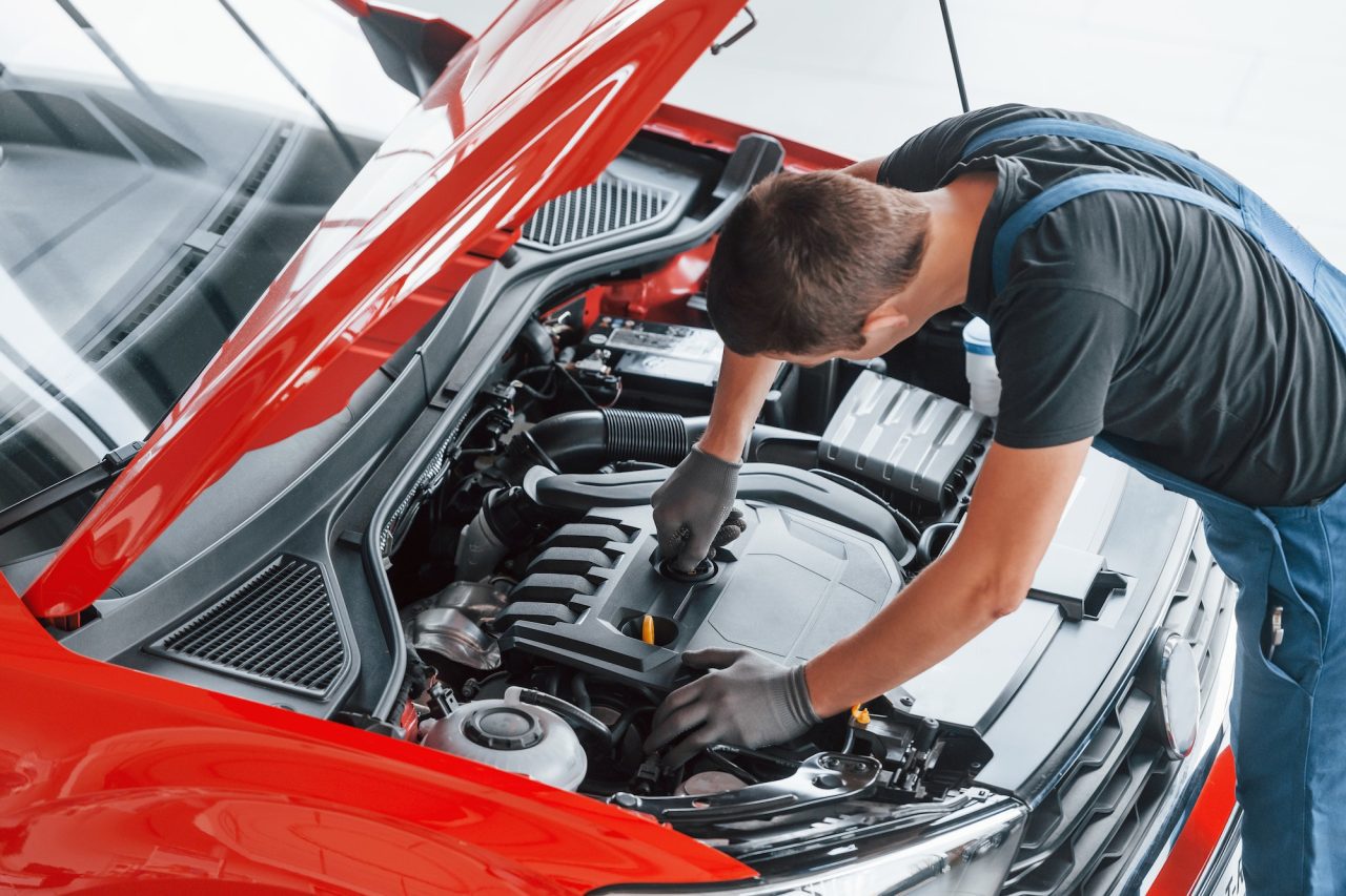 An AK Fast Fit Tyres in Feltham technician doing mot and service for a car.